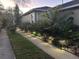 Landscaped pathway with decorative lighting leading to a well-maintained home exterior with mature trees at 19113 Doves Landing Dr, Tampa, FL 33647