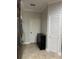 Hallway in kitchen area with white door and cabinet at 19113 Doves Landing Dr, Tampa, FL 33647