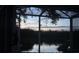 Beautiful lake view at dusk from the screened in porch of this home at 19113 Doves Landing Dr, Tampa, FL 33647