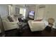 Spacious living room with an elegant white sectional sofa and a view of the lanai at 19113 Doves Landing Dr, Tampa, FL 33647