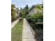 Landscaped walkway leading to the home, surrounded by lush greenery and flowers at 19113 Doves Landing Dr, Tampa, FL 33647