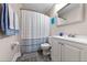 Bathroom with a vanity, mirror, and toilet under a shower curtain at 19823 Gulf Blvd # 42, Indian Shores, FL 33785
