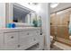 Bathroom with white vanity, framed mirror, and a glass-enclosed shower at 19823 Gulf Blvd # 42, Indian Shores, FL 33785