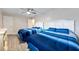 Bright bedroom featuring two beds, ceiling fan, and light-colored walls at 19823 Gulf Blvd # 42, Indian Shores, FL 33785