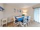 Dining room with a view with wood-look flooring, and beach-themed decor at 19823 Gulf Blvd # 42, Indian Shores, FL 33785