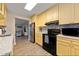 Kitchen with tiled backsplash and stainless appliances open to the living area at 19823 Gulf Blvd # 42, Indian Shores, FL 33785