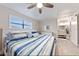Bedroom with coastal decor, wooden floors, and en-suite bathroom at 19823 Gulf Blvd # 42, Indian Shores, FL 33785