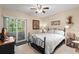Comfortable bedroom with sliding glass doors, neutral decor, and a ceiling fan at 20 Iris Pl, Oldsmar, FL 34677