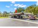 Carport showcasing multiple parking spaces, lush greenery, and an inviting entrance to the well-maintained property at 20 Iris Pl, Oldsmar, FL 34677
