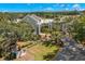 Exterior aerial view of a modern community clubhouse building with meticulously maintained landscaping and circular driveway at 20 Iris Pl, Oldsmar, FL 34677
