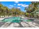 Outdoor swimming pool features multiple lounge chairs and surrounding landscaping for residents to relax and enjoy at 20 Iris Pl, Oldsmar, FL 34677