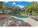Outdoor swimming pool features multiple lounge chairs and surrounding landscaping and offers an area to relax and enjoy at 20 Iris Pl, Oldsmar, FL 34677