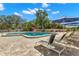 Community pool deck with ample seating and umbrellas on a sunny day at 20 Iris Pl, Oldsmar, FL 34677