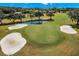 Aerial view of the golf course with sand traps, a pond, and a lush green putting green at 20 Iris Pl, Oldsmar, FL 34677