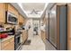 Well-lit kitchen with stainless steel appliances, tile countertops, and ample cabinet space for modern convenience at 20 Iris Pl, Oldsmar, FL 34677