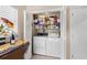 Convenient laundry closet with washer, dryer, and shelving for optimal organization and storage at 20 Iris Pl, Oldsmar, FL 34677