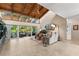 Open-concept living room with vaulted ceilings, tile floors, and scenic views at 20 Iris Pl, Oldsmar, FL 34677
