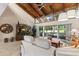 Spacious living room with vaulted wood ceilings and abundant natural light from sliding doors at 20 Iris Pl, Oldsmar, FL 34677