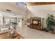 Open-concept living room featuring tile flooring, a high ceiling, and seamless transition to the dining area at 20 Iris Pl, Oldsmar, FL 34677
