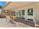 A large patio area with tables and chairs near folding glass doors offers a relaxing space for entertaining and dining at 20 Iris Pl, Oldsmar, FL 34677