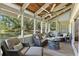 Relaxing screened patio featuring comfortable seating, a ceiling fan, and beautiful outdoor views at 20 Iris Pl, Oldsmar, FL 34677