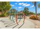 Splash pad area with colorful hoops and bucket drop, plus lounge chairs and umbrellas for a fun outdoor experience at 20 Iris Pl, Oldsmar, FL 34677
