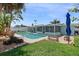 The backyard boasts a private pool, screened in patio, and lush tropical landscaping at 2310 Sunrise Se Dr, St Petersburg, FL 33705