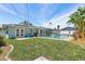 Spacious backyard featuring a pool, lush lawn, and inviting outdoor space at 2310 Sunrise Se Dr, St Petersburg, FL 33705