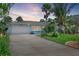 Charming single-story home with a well-manicured lawn, tropical landscaping, and an attached two-car garage at 2310 Sunrise Se Dr, St Petersburg, FL 33705