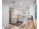 Well-lit kitchen featuring white cabinetry, stainless steel appliances, and breakfast bar at 2310 Sunrise Se Dr, St Petersburg, FL 33705