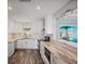 Bright kitchen with white cabinets, granite countertops, and stainless steel appliances at 2310 Sunrise Se Dr, St Petersburg, FL 33705