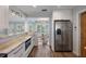 Bright kitchen with stainless steel refrigerator and breakfast bar overlooking the dining area at 2310 Sunrise Se Dr, St Petersburg, FL 33705