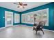 Bright living room with blue accent wall, lots of natural light, and view of the pool at 2310 Sunrise Se Dr, St Petersburg, FL 33705