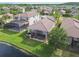 Aerial view of the backyard, lake and the house's screened-in patio and pool at 2632 Tarragona Way, Wesley Chapel, FL 33543