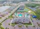Aerial view of community center with resort-style pool, tennis courts, and meticulously landscaped grounds at 2632 Tarragona Way, Wesley Chapel, FL 33543
