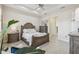 Bright bedroom with warm tones, a cozy seating area, and a view into the hallway at 2632 Tarragona Way, Wesley Chapel, FL 33543
