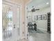 Beautiful entryway leading to a home office with a ceiling fan and golf decor at 2632 Tarragona Way, Wesley Chapel, FL 33543