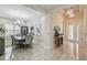 Inviting foyer and dining area featuring tile flooring, modern lighting, and neutral decor at 2632 Tarragona Way, Wesley Chapel, FL 33543