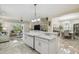 Open concept kitchen with an island, adjacent living area, and dining room at 2632 Tarragona Way, Wesley Chapel, FL 33543