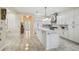 Bright kitchen features white cabinets, a marble backsplash, stainless steel appliances, and an island with pendant lighting at 2632 Tarragona Way, Wesley Chapel, FL 33543