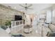 Spacious living room with a stone accent wall, modern furniture, and an open layout to the kitchen at 2632 Tarragona Way, Wesley Chapel, FL 33543