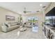 Bright living room with tile flooring, comfortable seating, and sliding glass doors to the outside at 2632 Tarragona Way, Wesley Chapel, FL 33543