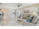 Spacious living room with tile floors and ample natural light, open to the kitchen at 2632 Tarragona Way, Wesley Chapel, FL 33543