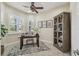 Cozy home office with plantation shutters, a ceiling fan and stylish decor at 2632 Tarragona Way, Wesley Chapel, FL 33543