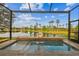 Heated spa pool offers serene lake views, lush landscaping, and a screened lanai at 2632 Tarragona Way, Wesley Chapel, FL 33543