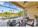 Inviting covered lanai offering a water view, outdoor seating, and spa at 2632 Tarragona Way, Wesley Chapel, FL 33543