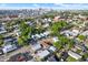 Aerial view of neighborhood showcases lush greenery, clear skies, and city skyline at 2818 N 19Th St, Tampa, FL 33605