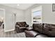 Cozy living room features brown leather seating and a sunlit window at 2818 N 19Th St, Tampa, FL 33605