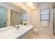 Bathroom showcasing a white vanity, a large mirror, and bright lighting at 2932 Sweetgum S Way, Clearwater, FL 33761