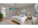 Bright bedroom featuring modern decor, two windows, and neutral walls at 2932 Sweetgum S Way, Clearwater, FL 33761